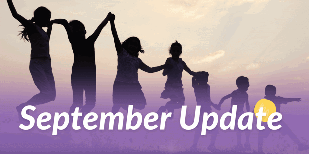 september update: silhouettes of seven children holding hands and jumping
