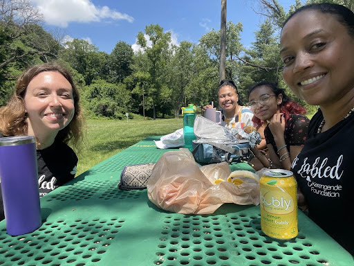 amber clayborne and others at a picnic table in nature