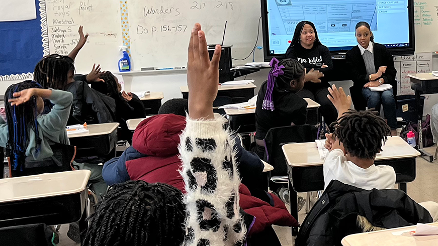amber and teacher in a classroom setting with kids