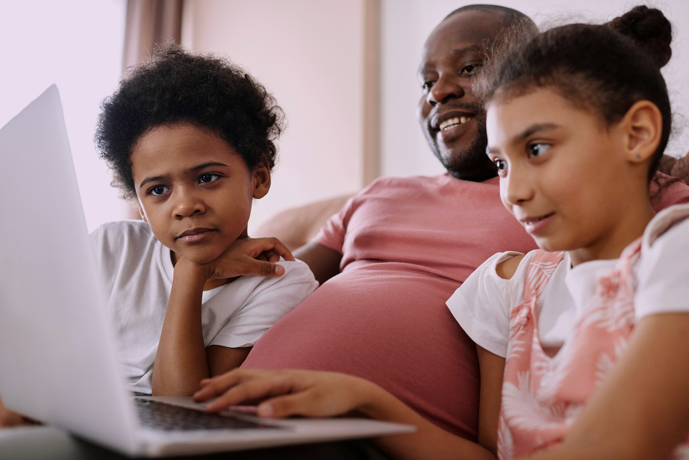 a family looking at a laptop together