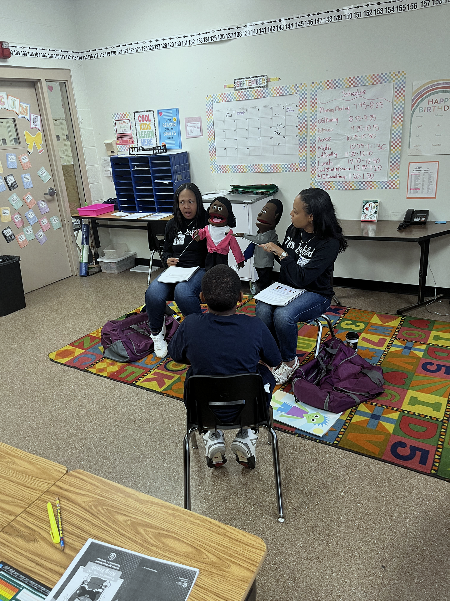 amber clayborne and teacher using puppets to teach a workshop