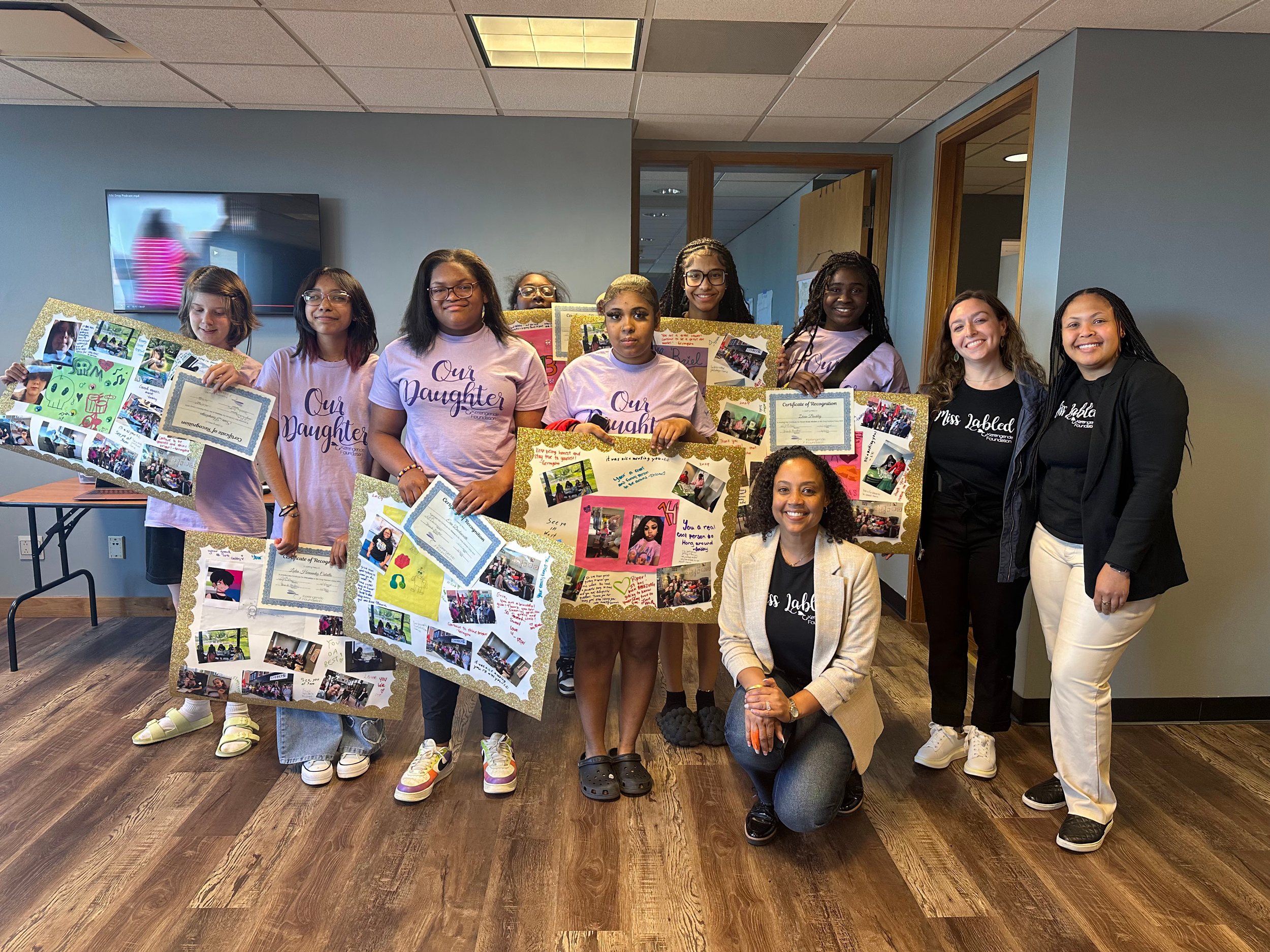 group of girls and women holding posters