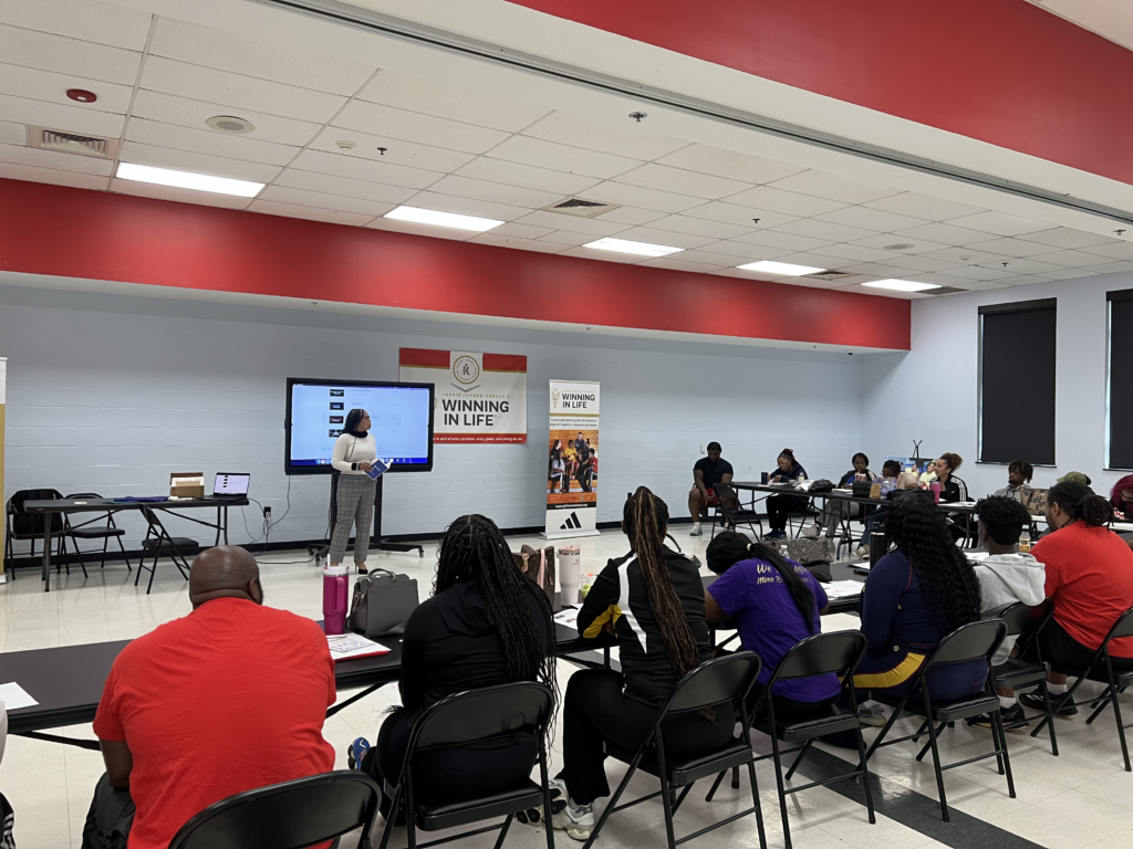 people in an in-person seminar watching a video